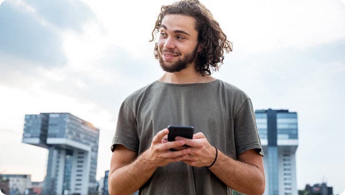 A picture of a young consumer using Open Banking on a smartphone