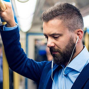 A commuter listening a podcast on data solutions