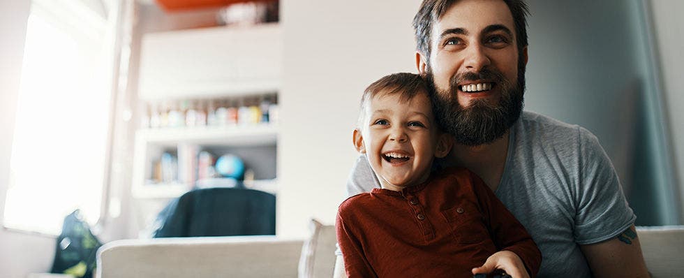 Father and son at home playing computer games