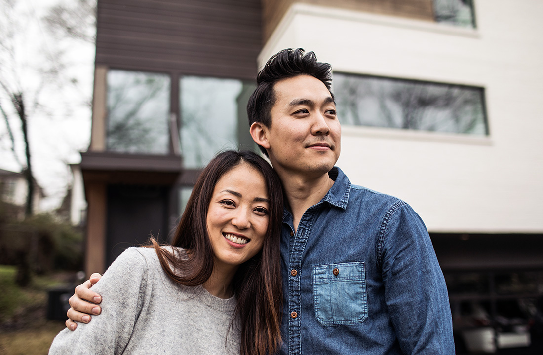 Couple outside of a modernist house.
